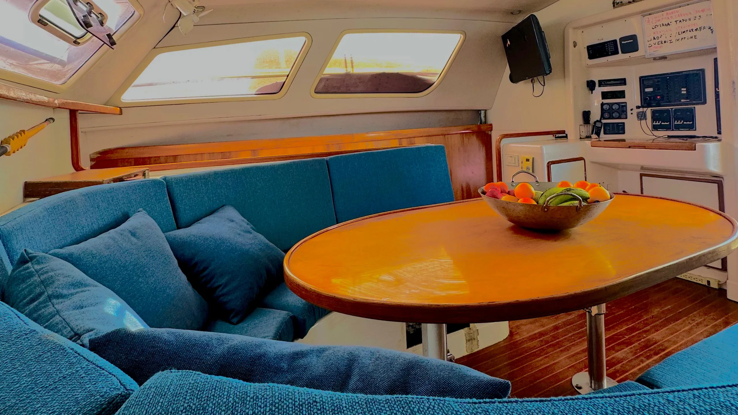 Yacht interior with blue seating and a dining table