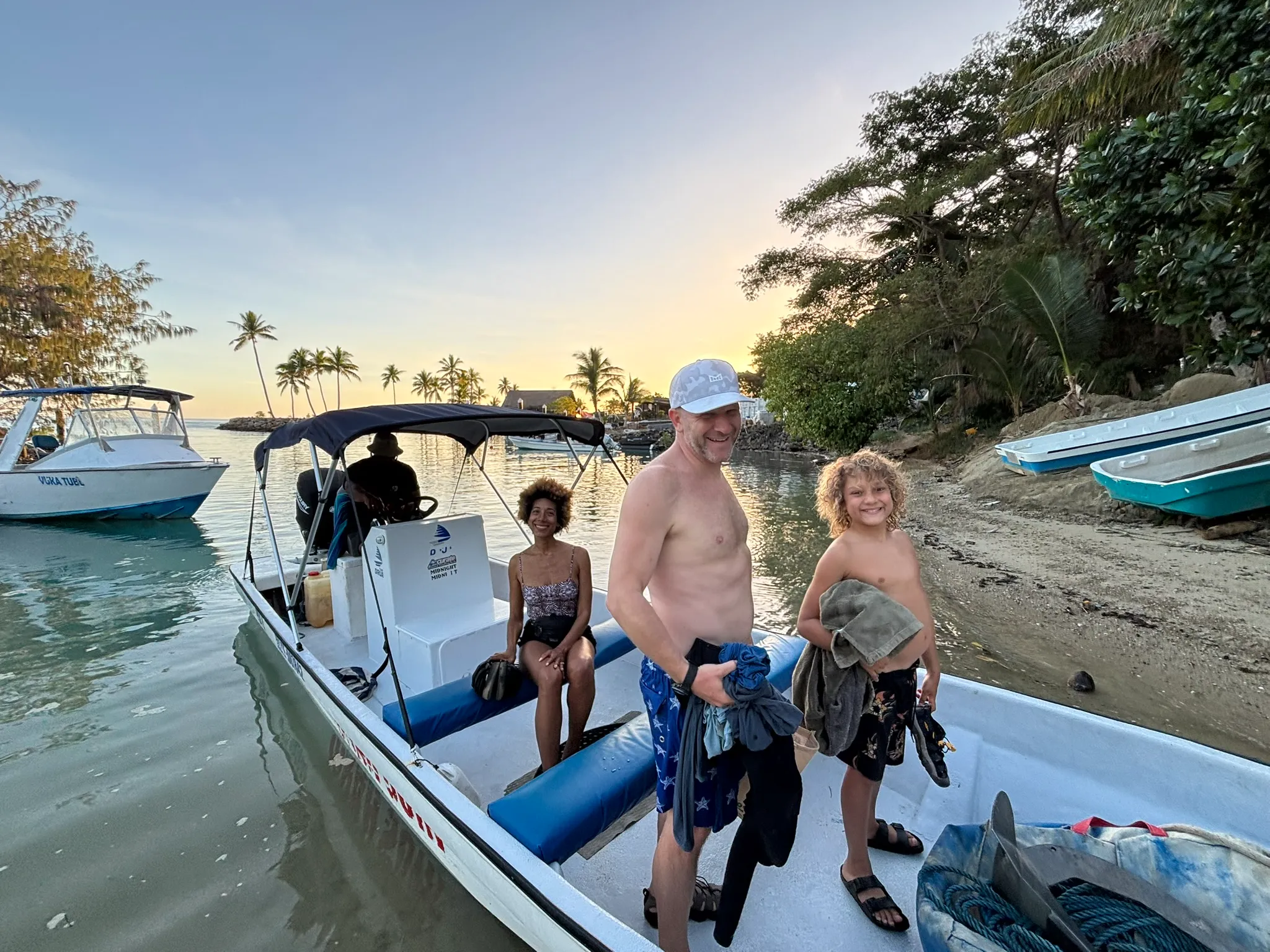 Guests beside a beach departure boat